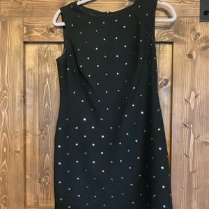 Black dress with metal button detail.